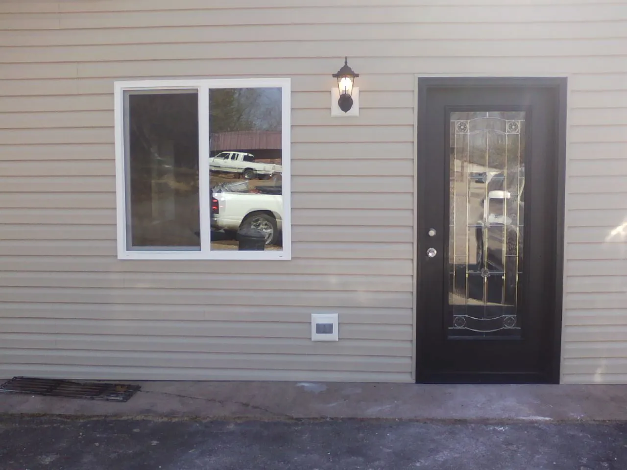 New siding, window and entry door on the side of an addition in Yacolt